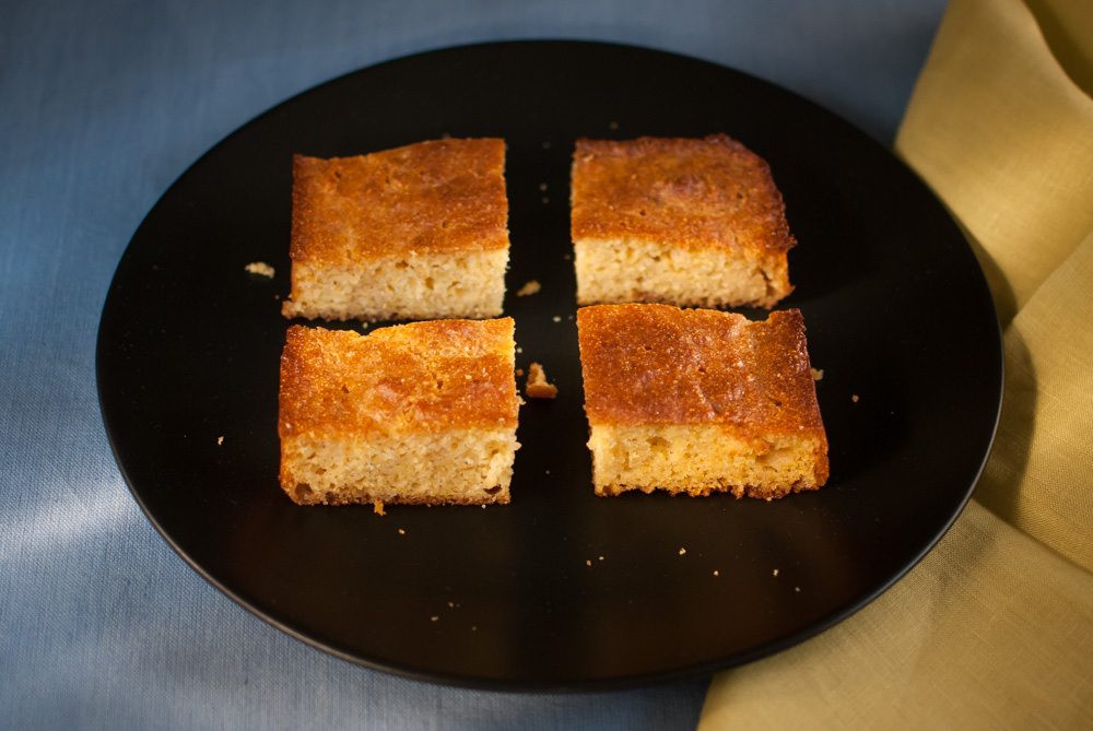 This recipe replicates the crusty and crunchy style of cornbread that is made in a cast iron skillet (but uses a normal cake tin). It also uses a cornmeal that can now be found in most supermarkets.