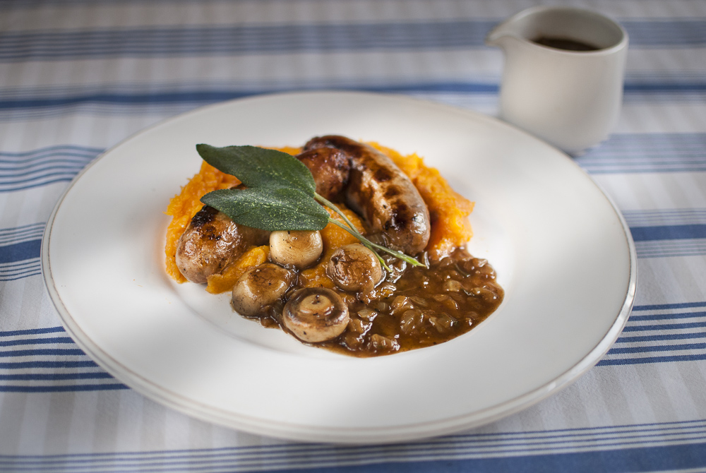 Sausages and seasonal squash make a great combo. Here they are served with sage and onion gravy to make a perfect autumn supper.